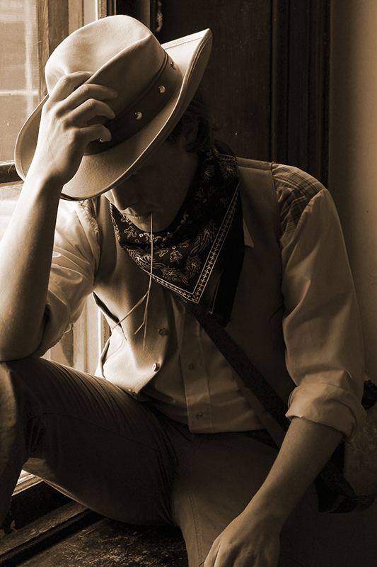 Cowboy by the window in sepia