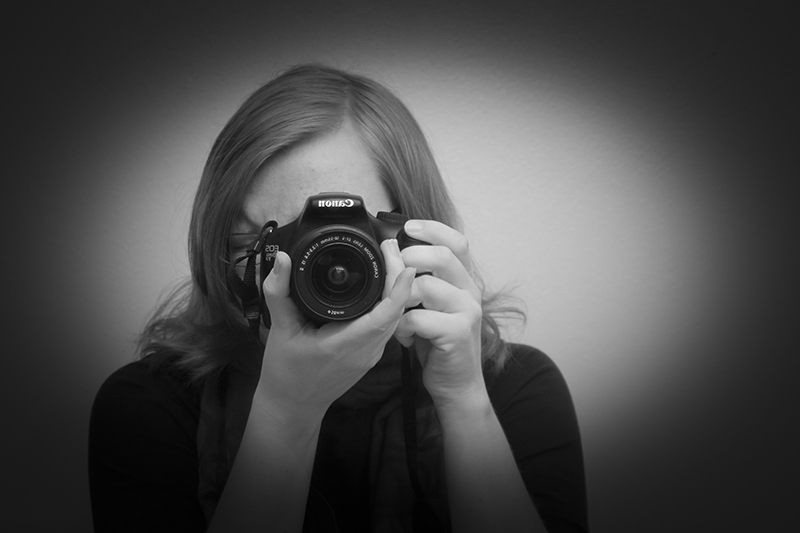 self-portrait, looking through camera; black and white